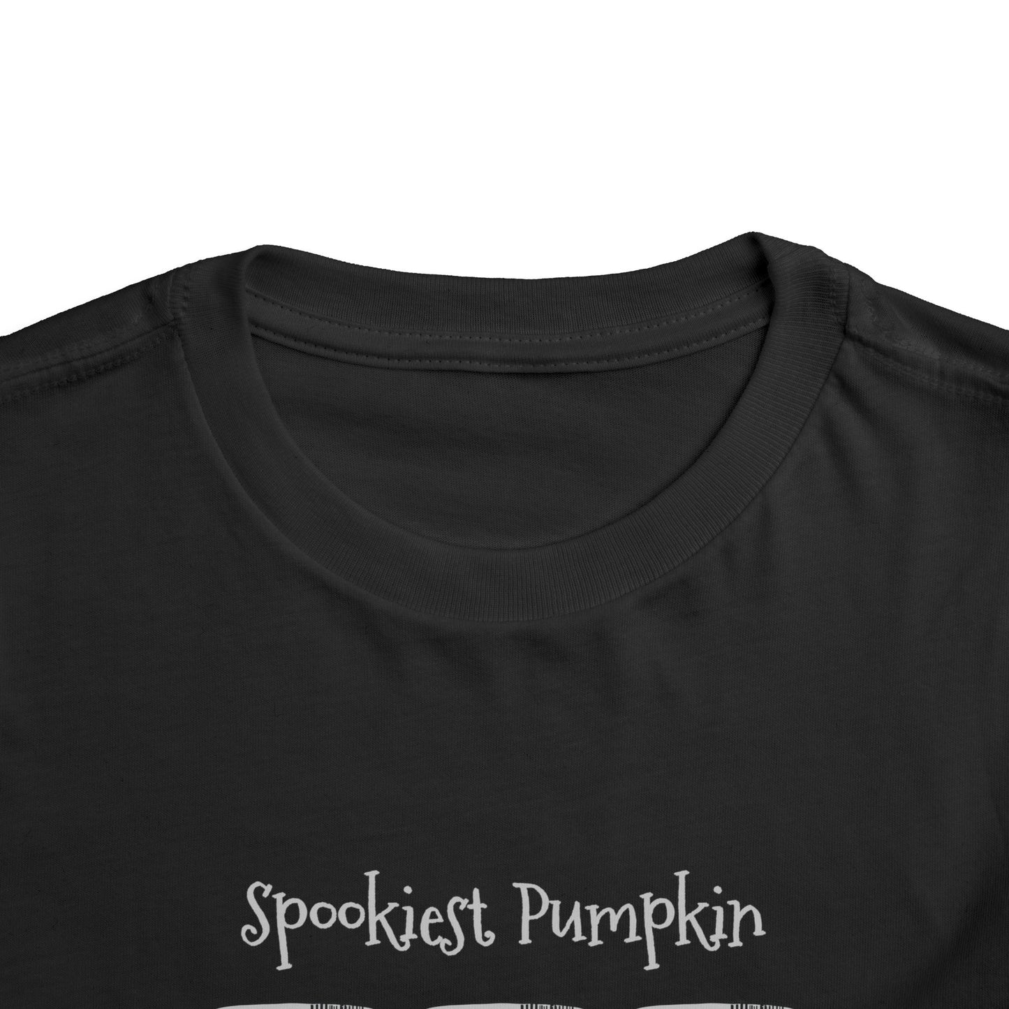 Close-up of the collar and upper chest of the Printify Toddler Tee Halloween Spookies Pumpkin in the Pantry—a playful black pumpkin shirt perfect for your toddler’s spooky outfit.