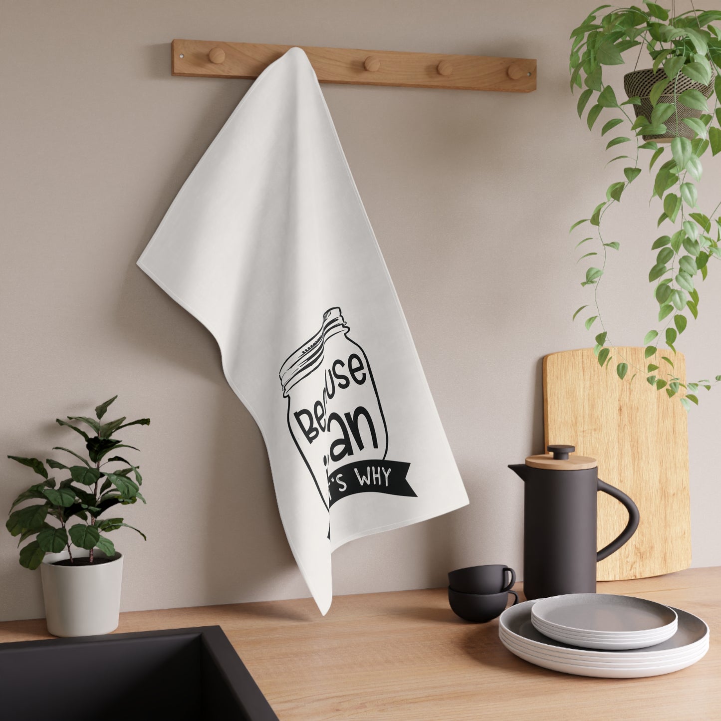 The Purposeful Pantry's "Because I Can, That's Why" Kitchen Tea Towel, featuring a mason jar design, hangs above a modern kitchen counter—ideal for any canning enthusiast or food preservationist.