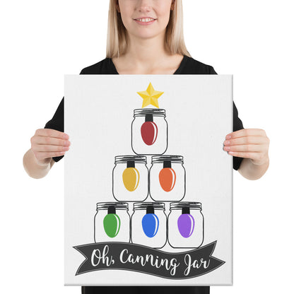 A woman holding up a canvas that says Oh Canning Jar Christmas Wall Art, made by The Purposeful Pantry.