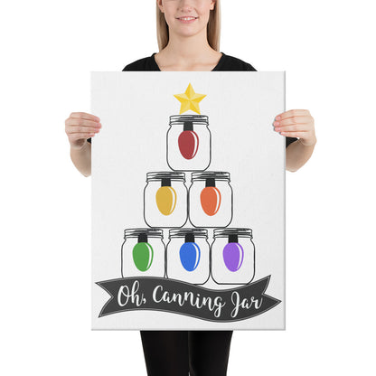 A woman holding up a Oh Canning Jar Christmas Wall Art canvas that says oh canning you from The Purposeful Pantry.