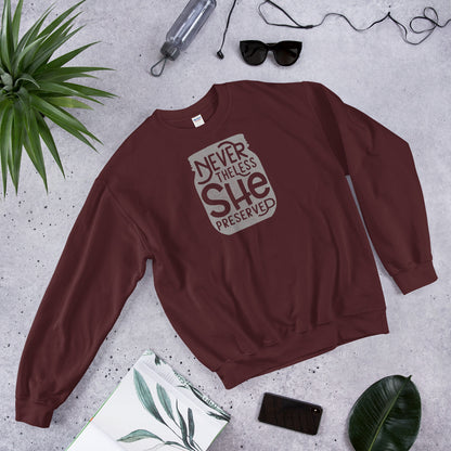 A maroon sweatshirt from The Purposeful Pantry brand with the words, "Nevertheless She Preserved