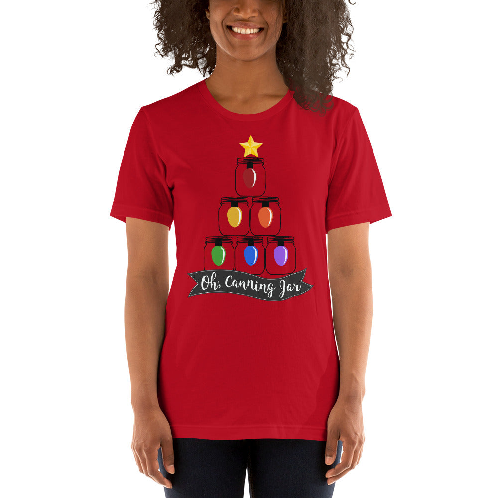 A woman wearing an Oh Canning Jar Christmas Short Sleeve T-Shirt by The Purposeful Pantry, with a christmas tree on it.