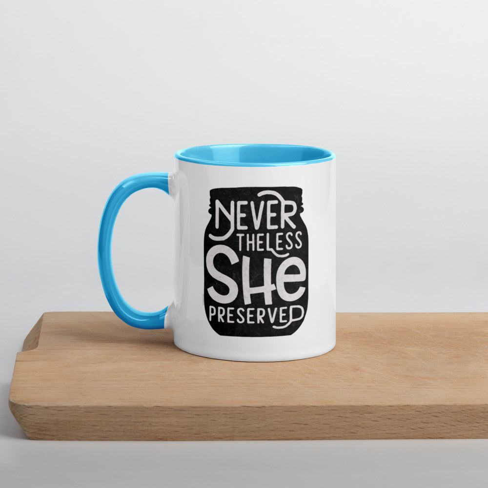 A coffee mug with the words "never without she preserved" on it would be the Neverthless She Preserved Mug with Color Inside, from The Purposeful Pantry.